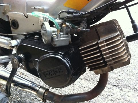 1999 Tomos Targa - Close-up of a Tomos moped engine, showing the carburetor and exhaust system.