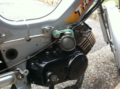 1999 Tomos Targa - Detail of a moped's engine and frame, showing the 'Tomos' branding and a 'Targa' decal on the silver body.