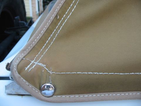 1992 Ford Bronco - Close-up of a tan soft top corner showing stitching and metal snaps.