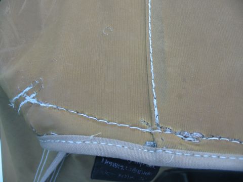 1992 Ford Bronco - Close-up of tan fabric with visible stitching and some wear, possibly a vehicle soft top.