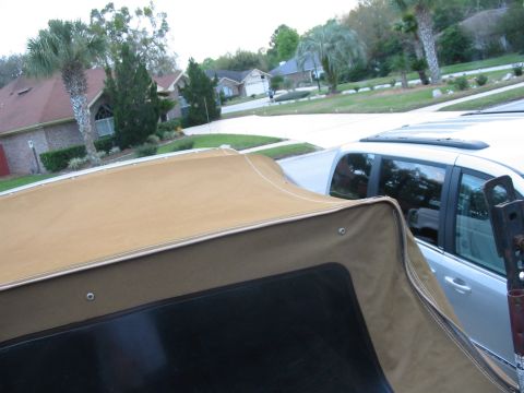 1992 Ford Bronco - Tan soft top installed on a vehicle, with a silver SUV parked nearby.
