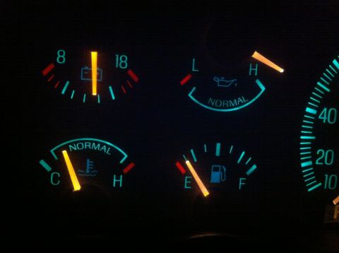 1990 Ford Bronco - The dashboard displays illuminated gauges for battery, oil, temperature, and fuel levels.