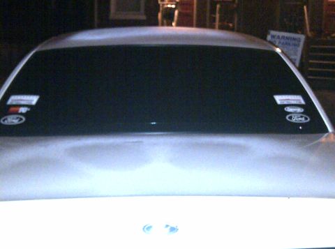 2000 Ford Crown Victoria - Rear view of a 2000 Ford Crown Victoria, Ford oval stickers on the tinted rear window.