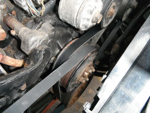 1988 Ford Bronco - Close-up view of the engine's pulley system and belts.