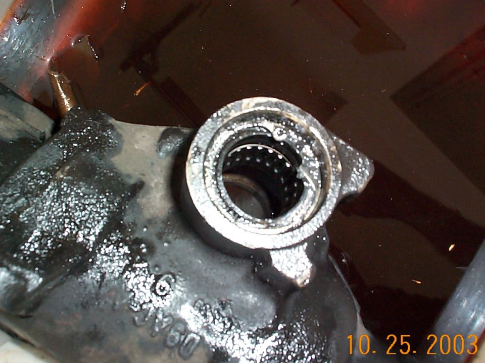Snap ring over the trashed seal. It helps to have a good set of ring pliers.