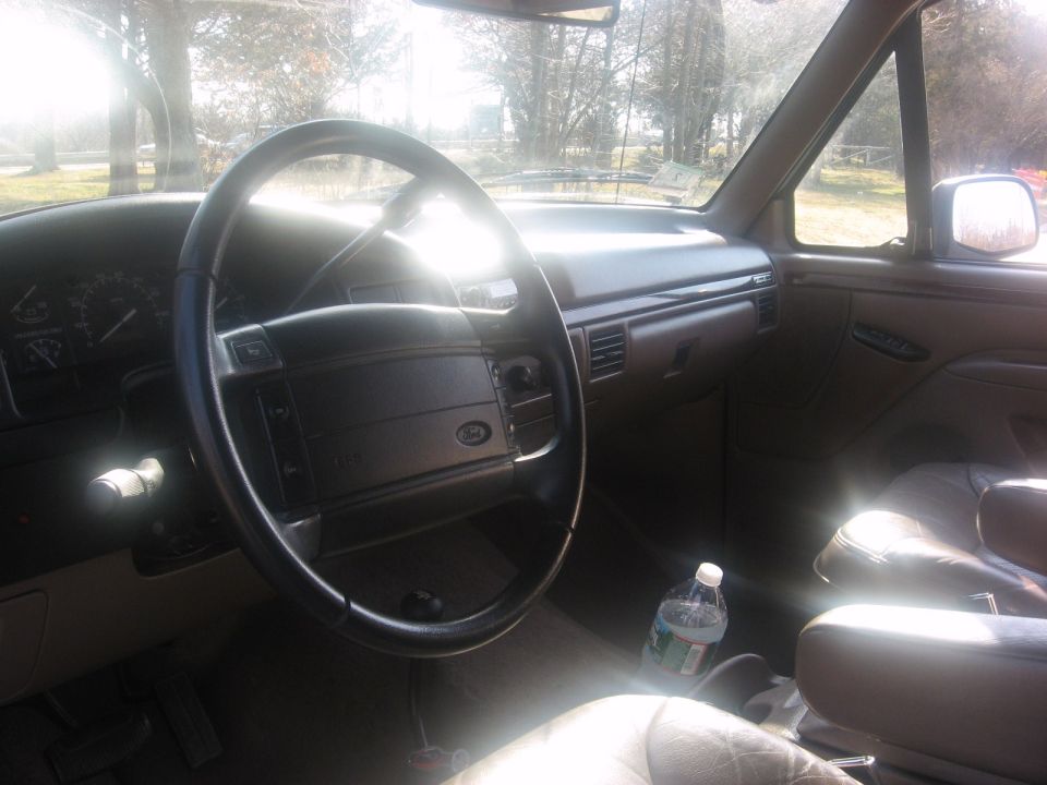 1996 Ford Bronco interior showing steering wheel, dashboard, and passenger seat