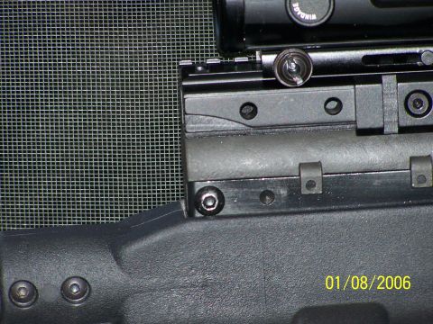 1989 Ford Bronco - A close-up view of a rifle's receiver and scope mount, with a date stamp and website visible.