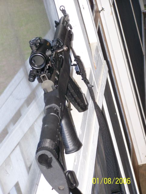 1989 Ford Bronco - A rifle with a scope and sling is visible, positioned against a white railing.