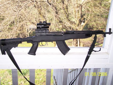 1989 Ford Bronco - A Chinese Paratrooper SKS rifle with an aftermarket stock and optic is displayed outdoors.