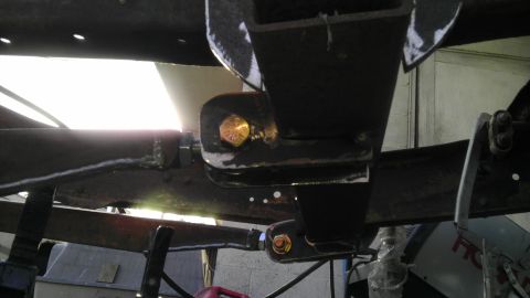 1987 Ford Ranger - Close-up of vehicle suspension components, showing metal brackets and bolts.