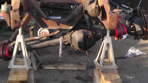 1987 Ford Ranger - Front axle assembly on jack stands, showing differential and suspension parts.