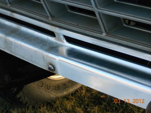 1978 Ford Bronco - Detail of a vehicle's front end, including a chrome bumper and grille, with a date stamp.
