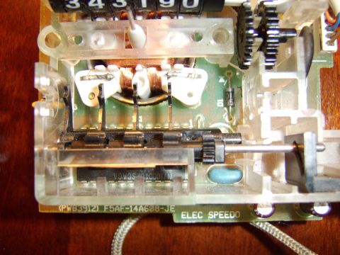 1996 Mercury Grand Marquis - Internal components of an electronic speedometer, showing circuit board and mechanical parts.