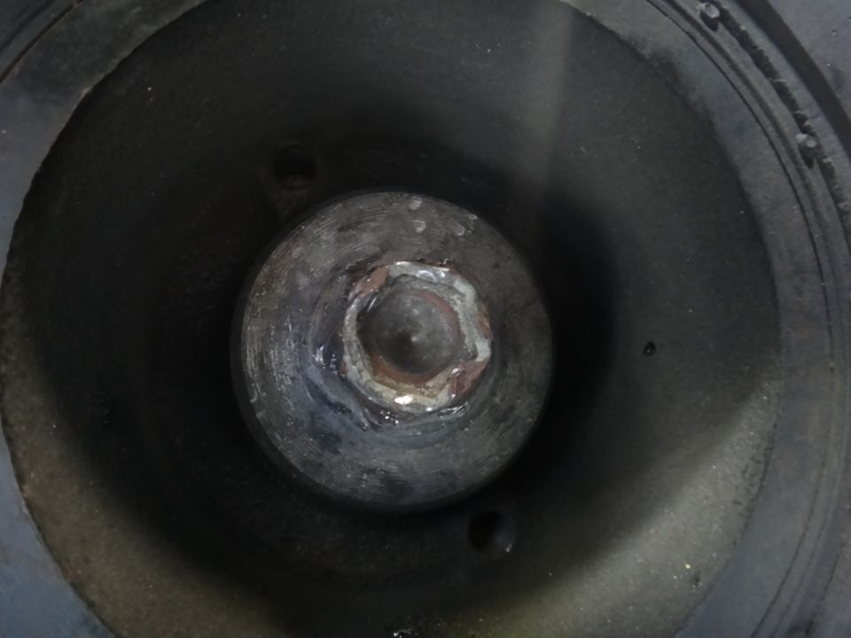 Bolt head with hexagonal recess, set within a dark, cylindrical component