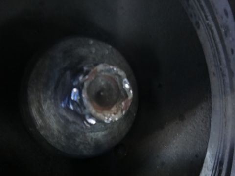 1993 Ford Taurus - Close-up view of a welded lug nut on a wheel hub, indicating a non-standard modification.