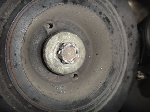 1993 Ford Taurus - This is a close-up view of a crankshaft pulley bolt, showing wear and dirt accumulation.