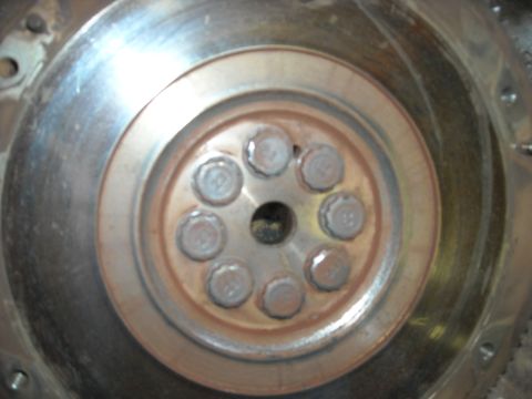 1979 Ford F-150 - This image shows a close-up view of several bolts arranged in a circular pattern on a metal component.