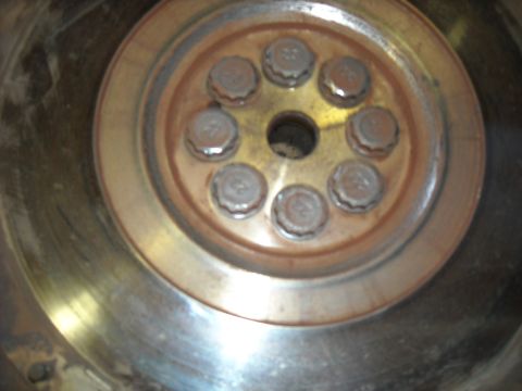 1979 Ford F-150 - A flywheel component with visible bolts is shown in a close-up view.