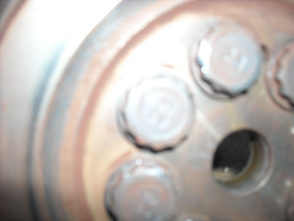 Close-up of lug nuts on a wheel hub