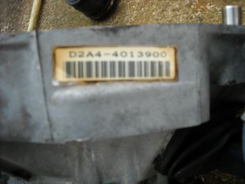 1979 Ford F-150 - A close-up view of a metal component with a label containing alphanumeric characters and a barcode.