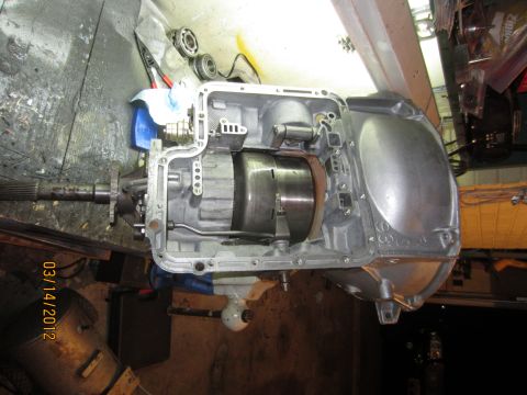 1979 Ford Bronco - Transmission housing disassembled on a workbench, showing internal gears and torque converter.