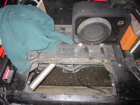 2008 Jeep Wrangler - This photo shows the interior of a vehicle, focusing on a subwoofer and wiring, with a WARN winch visible.