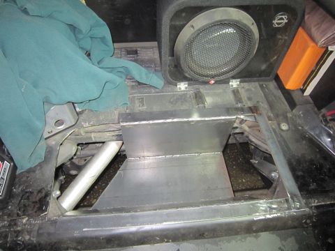 2008 Jeep Wrangler - A custom metal storage compartment and speaker are visible inside a vehicle's interior.
