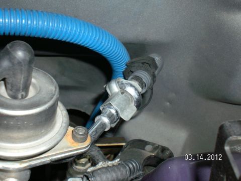 1996 Ford Bronco - A close-up view of a vehicle's fuel line fitting and associated plumbing.