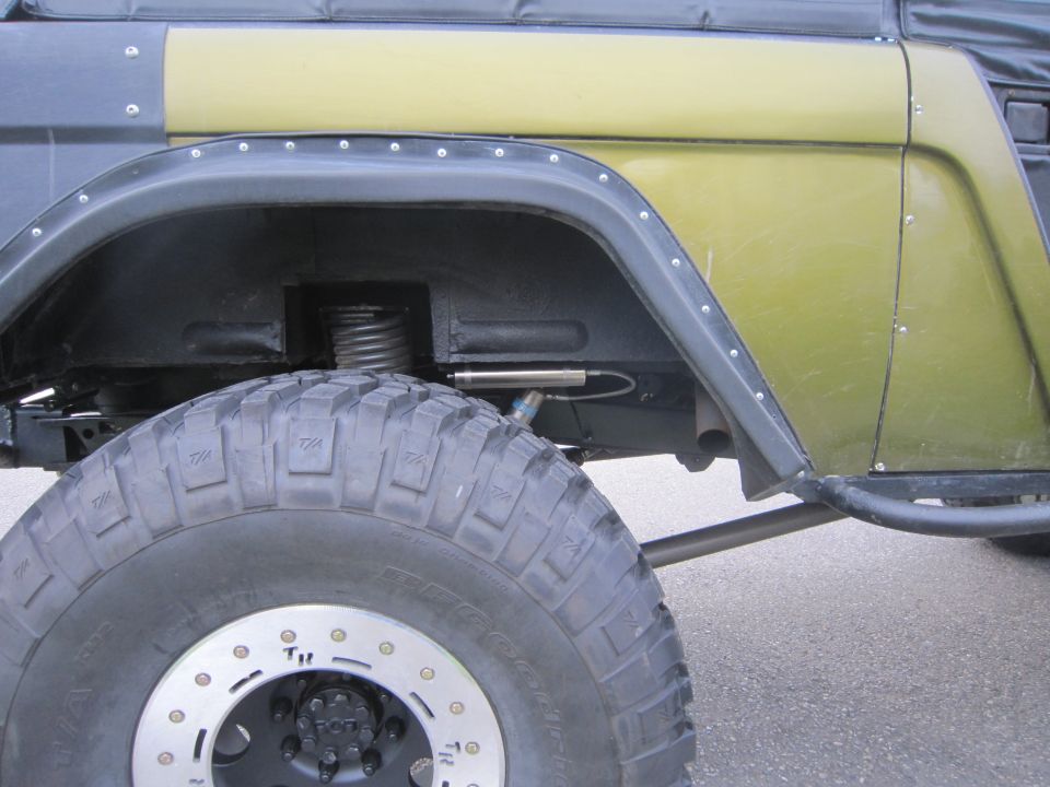 1974 Ford Bronco side view showing fender flare, large tire, and suspension components