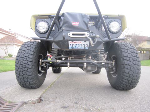 1974 Ford Bronco - Modified 1974 Ford Bronco front view showing off-road tires and winch setup.