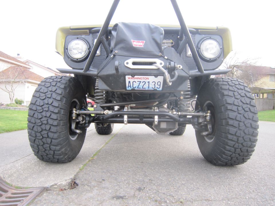 1974 Ford Bronco front end with winch, large tires, and custom bumper