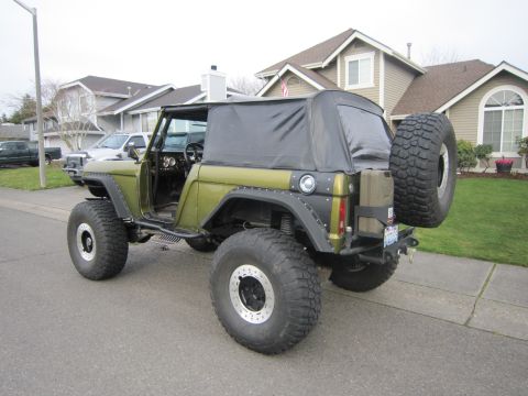1974 Ford Bronco - This modified 1974 Ford Bronco is seen from a rear three-quarter angle on a suburban street.