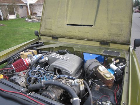 1974 Ford Bronco - Vehicle engine bay with a Ford Mustang fuel injection system and aftermarket air intake installed.