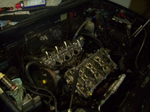 2003 Hyundai Tiburon - The engine's internal components are exposed for maintenance or repair in this engine bay.