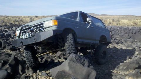 1989 Ford Bronco - This modified Ford Bronco is shown navigating a challenging rocky terrain.