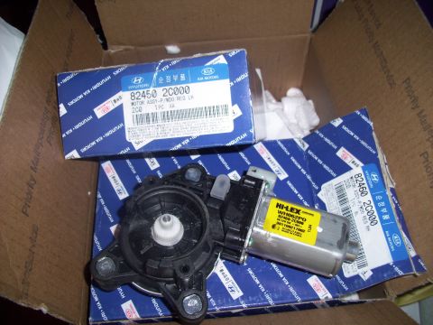2003 Hyundai Tiburon - Hyundai window motor part in a cardboard box with other parts.