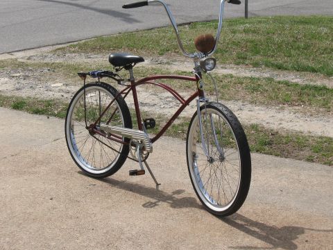 1994 Ford Bronco - A vintage-style cruiser bicycle with a distinctive frame and chrome accents is shown outdoors.