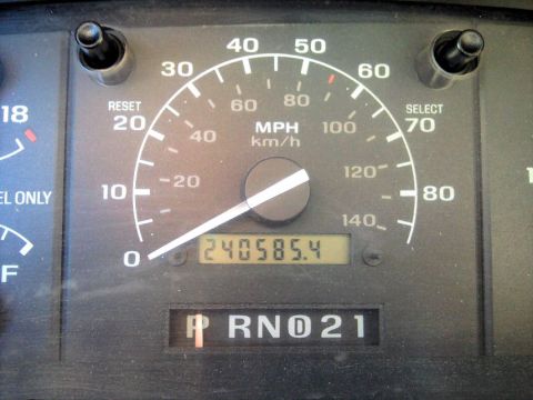 1994 Ford Bronco - Vehicle's dashboard gauges and gear selector are visible in this close-up shot.