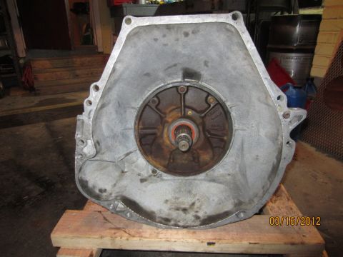 1979 Ford Bronco - Transmission bell housing with a central opening and splined shaft is shown on wooden blocks.
