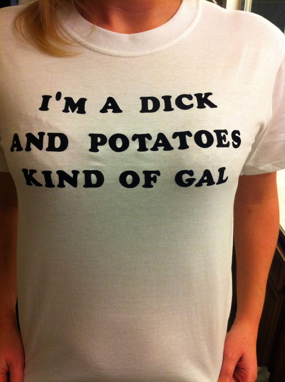 White t-shirt with black text reading 'I'M A DICK AND POTATOES KIND OF GAL'