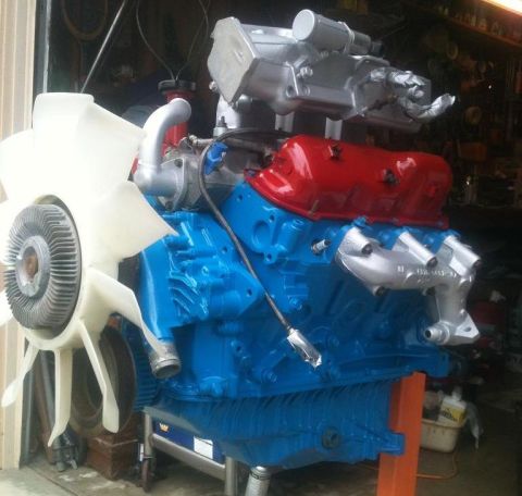 1988 Ford Bronco II - Engine assembly on a stand, painted blue with red valve covers and silver intake.