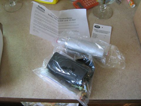 1988 Mercury Grand Marquis - Holley fuel filters and associated paperwork are laid out on a countertop.