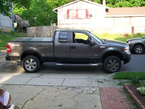 2008 Ford F-150 - This pickup truck has a "4x4" decal on the bed and a tonneau cover.
