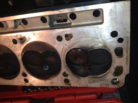 1992 Ford Bronco - This is a close-up view of an engine cylinder head, showing wear and tear around the valve seats.