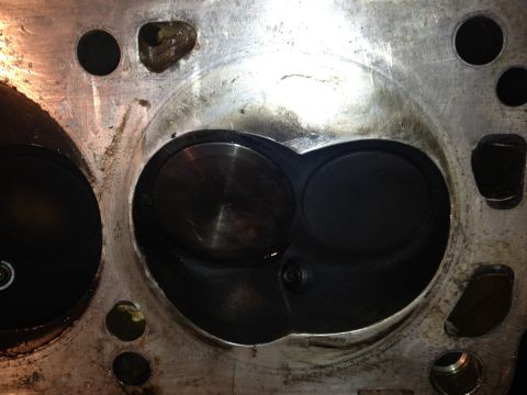 1992 Ford Bronco - Close-up of an engine cylinder head, revealing internal components and signs of use.