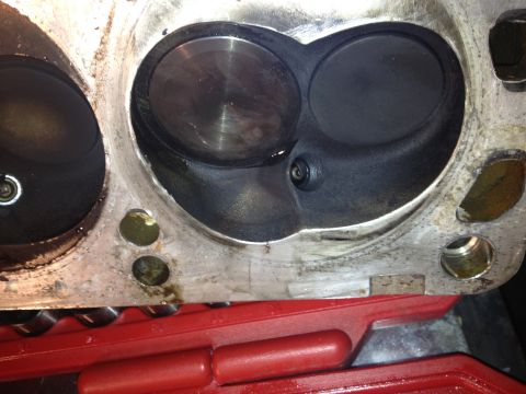 1992 Ford Bronco - Engine cylinder head showing intake and exhaust ports, and a spark plug hole.
