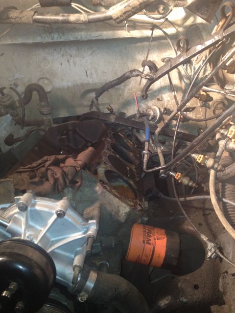 1992 Ford Bronco - Close-up view of a disassembled engine, showing the engine block, oil filter, and water pump.