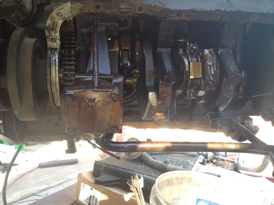 Close-up of engine crankshaft and connecting rods with oil