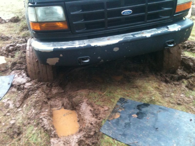 Front view of a 1994 Ford F-150 stuck in mud