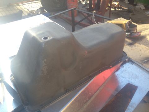 1992 Ford Bronco - A close-up view of a vehicle's oil pan, likely removed for maintenance or after a motor rebuild.